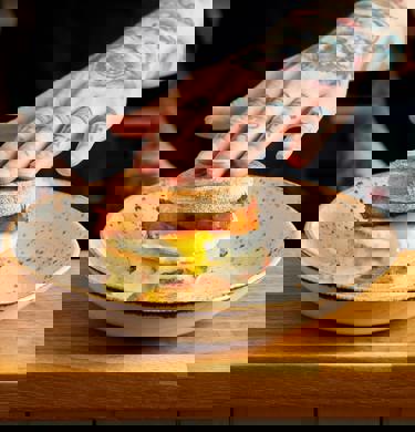 Our signature Sausage breakfast muffin. Sausage patty, melted cheese, runny fried egg and homemade hash browns